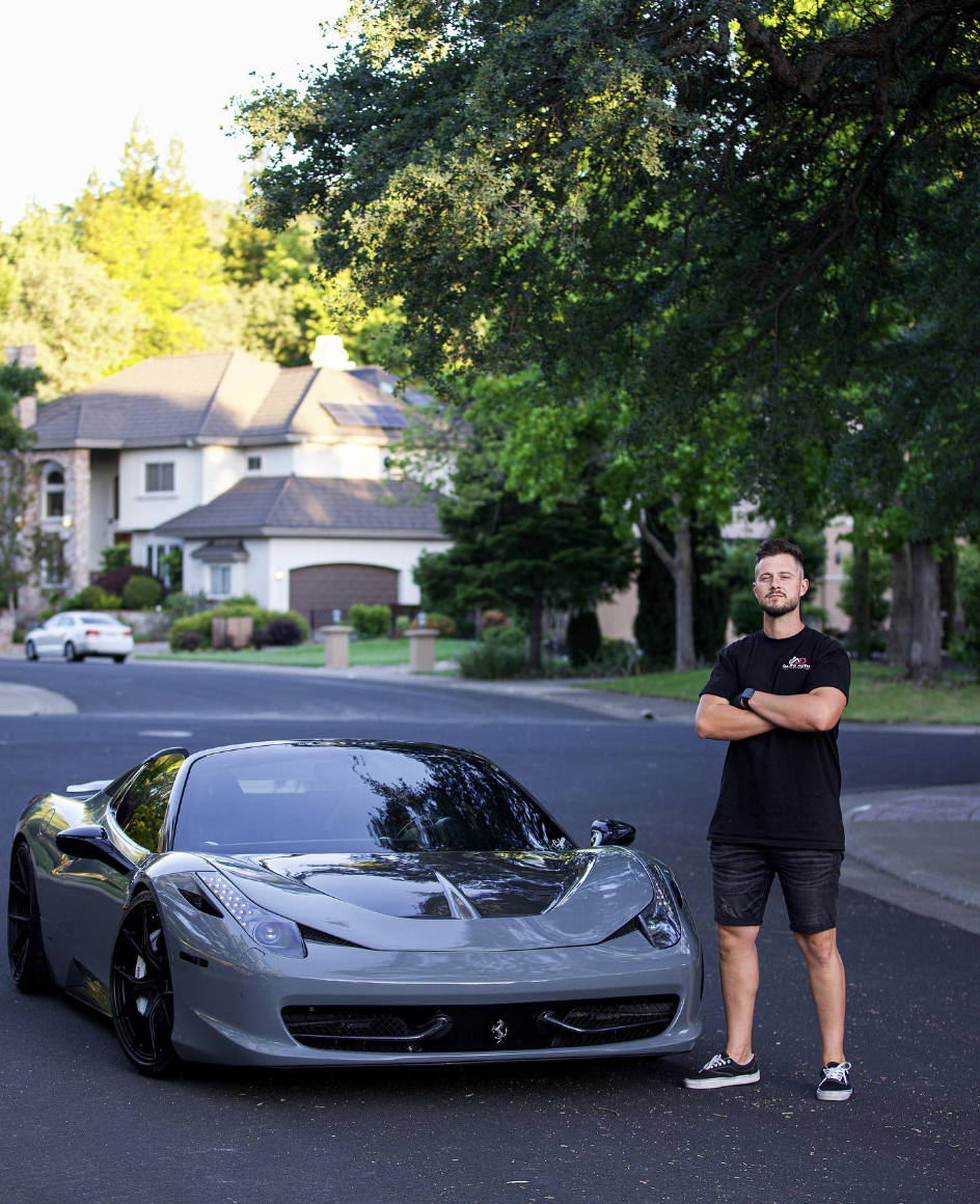 Dave, owner of Dave's Auto Detailing, standing next to a detailed sports car