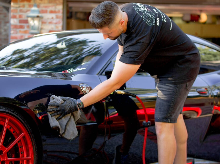 Dave detailing a black sports car in Phoenix